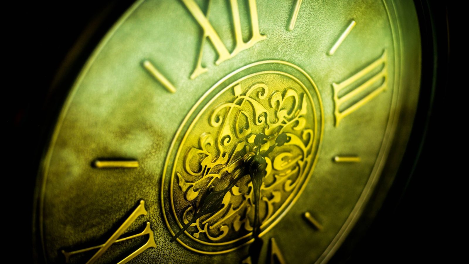 Close-up of an antique clock face with Roman numerals.